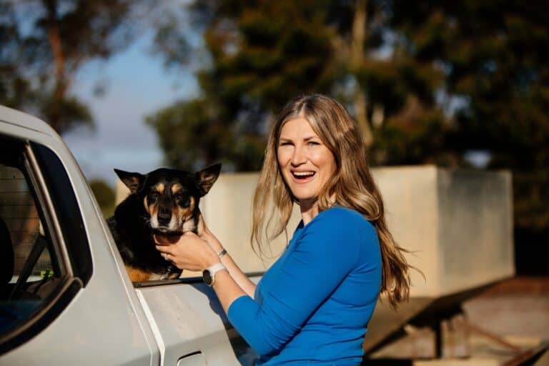 Smiling woman with her dog in a truck