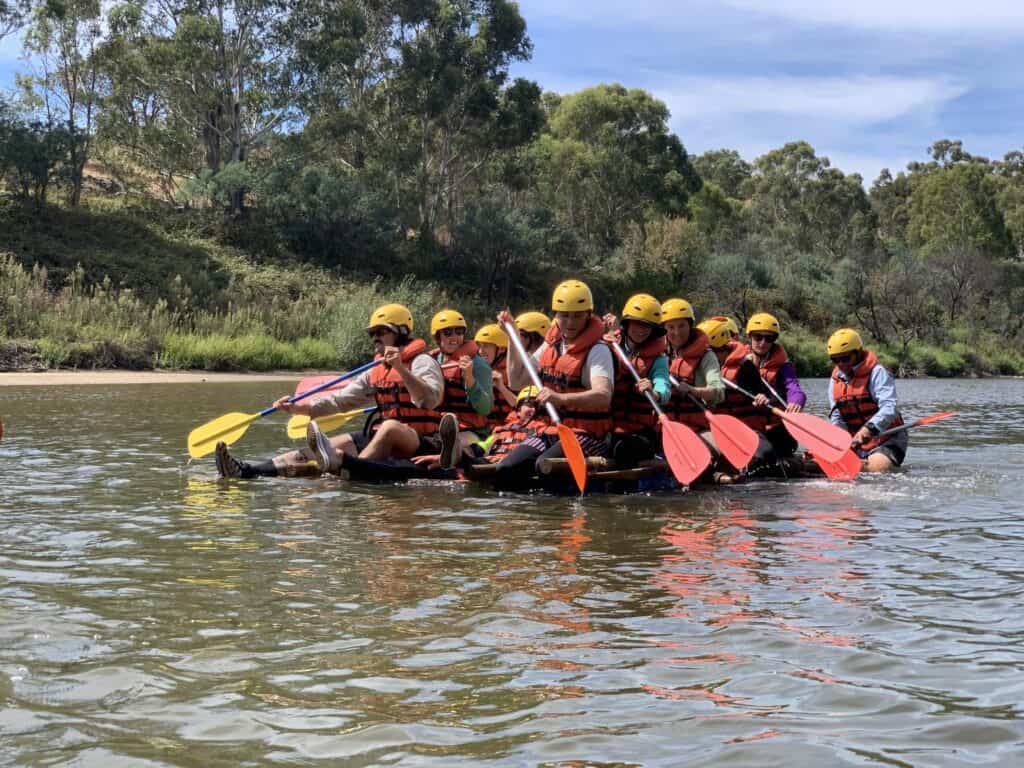 Group of people paddling on a raft