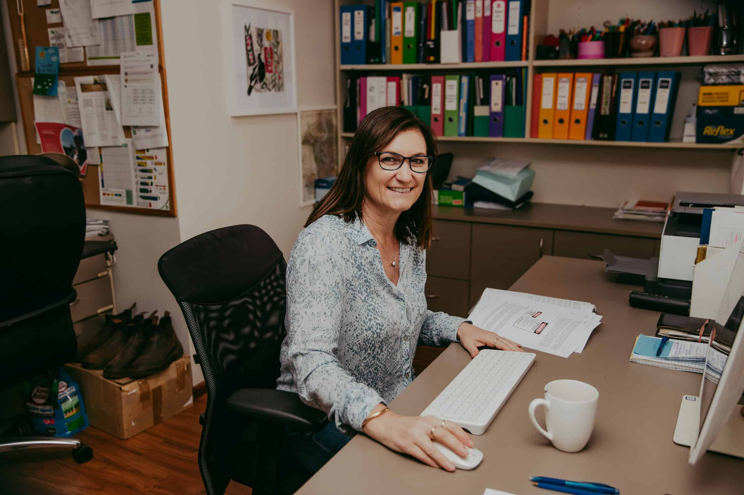 Woman sitting by a desktop computer