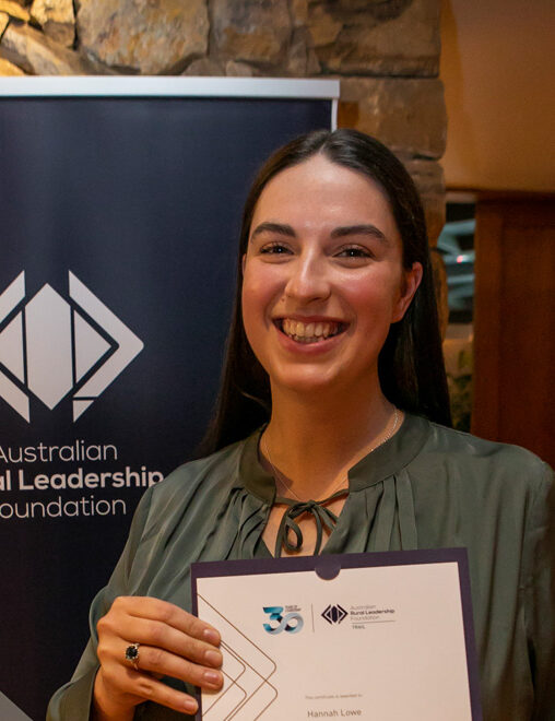 Photo of woman smiling holding graduation certificate
