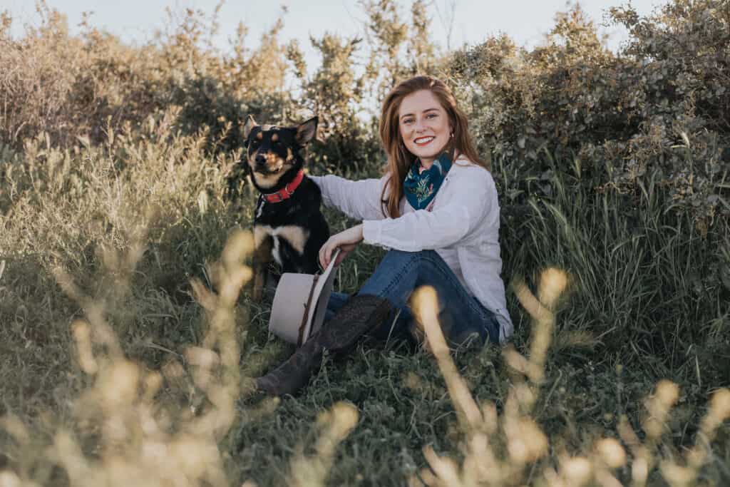 headshot of girl and dog with saltbush background