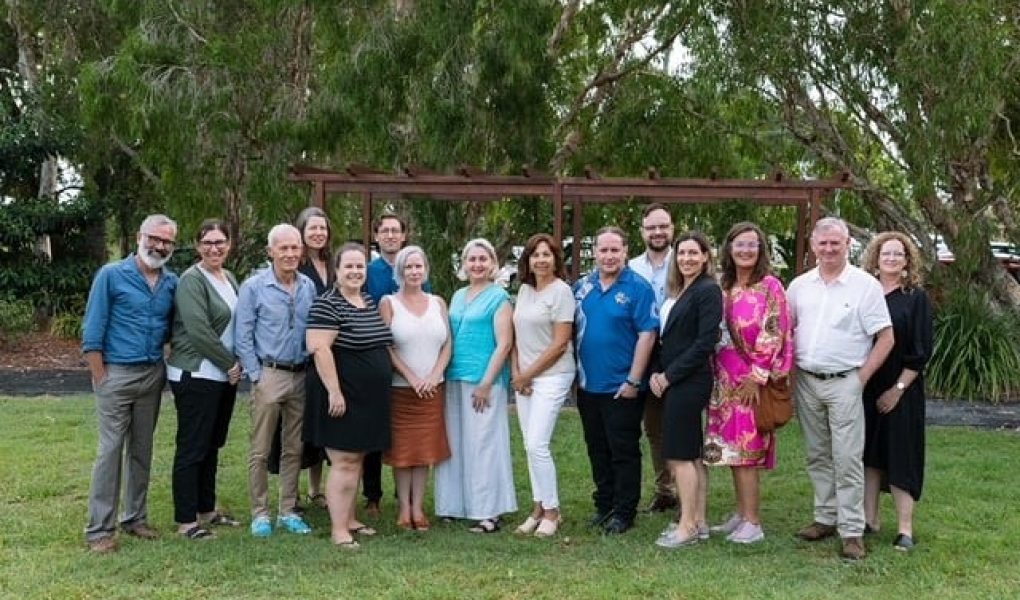 A group of Northern Rivers Leading Australian Resilient Communities program alumni standing in a park in front of trees.
